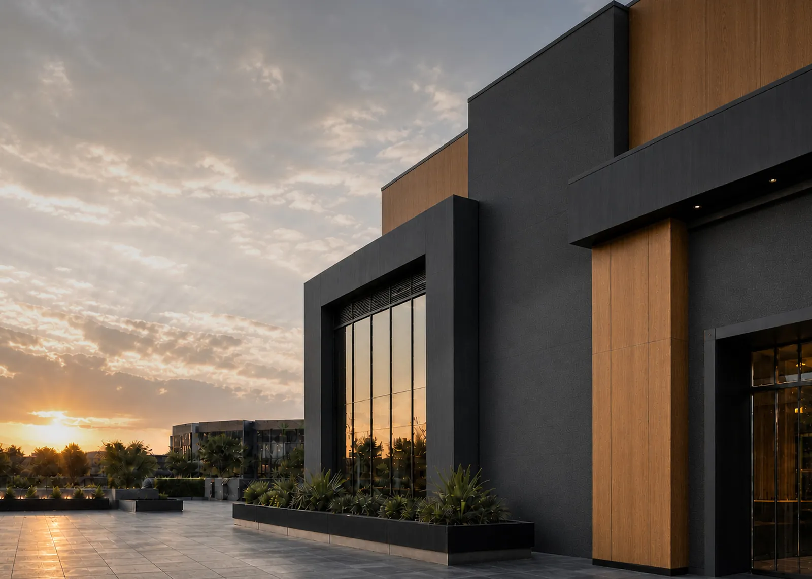 Modern house with black and warm oak facade panels at sunset